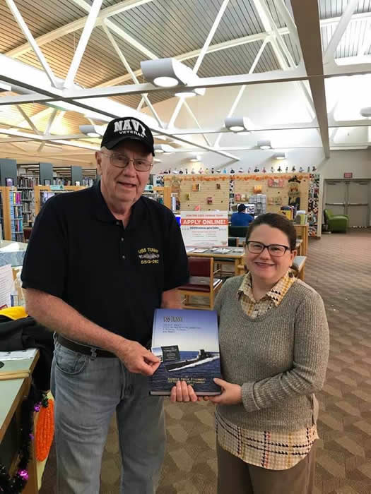 Author and former resident Ray Olszewski presents a copy of his latest book, USS TUNNY: A History, Tribute, and Memoir to Suzy Ruskin, Librarian, Natrona Heights Community Library, PA.
