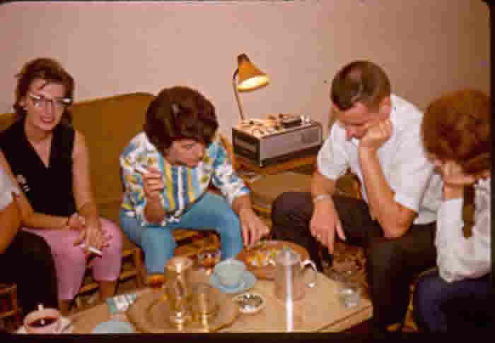 Local Scene - fellow US Embassy personnel enjoying working a Chinese marble puzzle in my home.